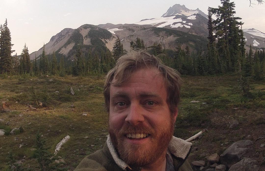 Ken Walsh taking a selfie with Mount Jefferson behind him