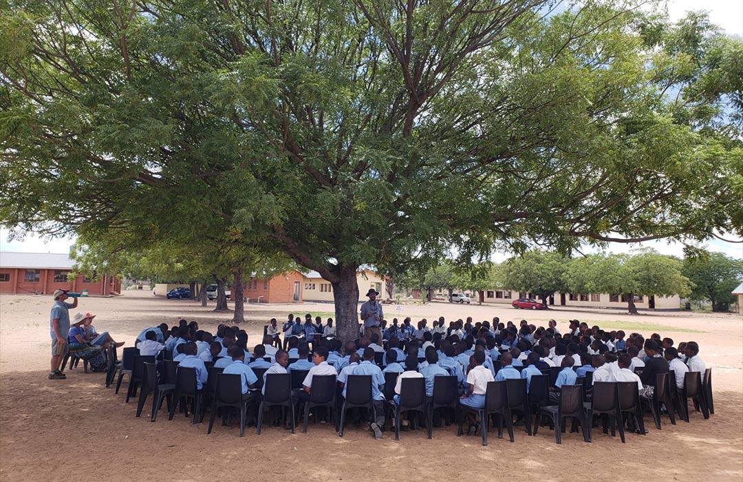 Zack Bango presenting talking to school children in Botswana about malaria.