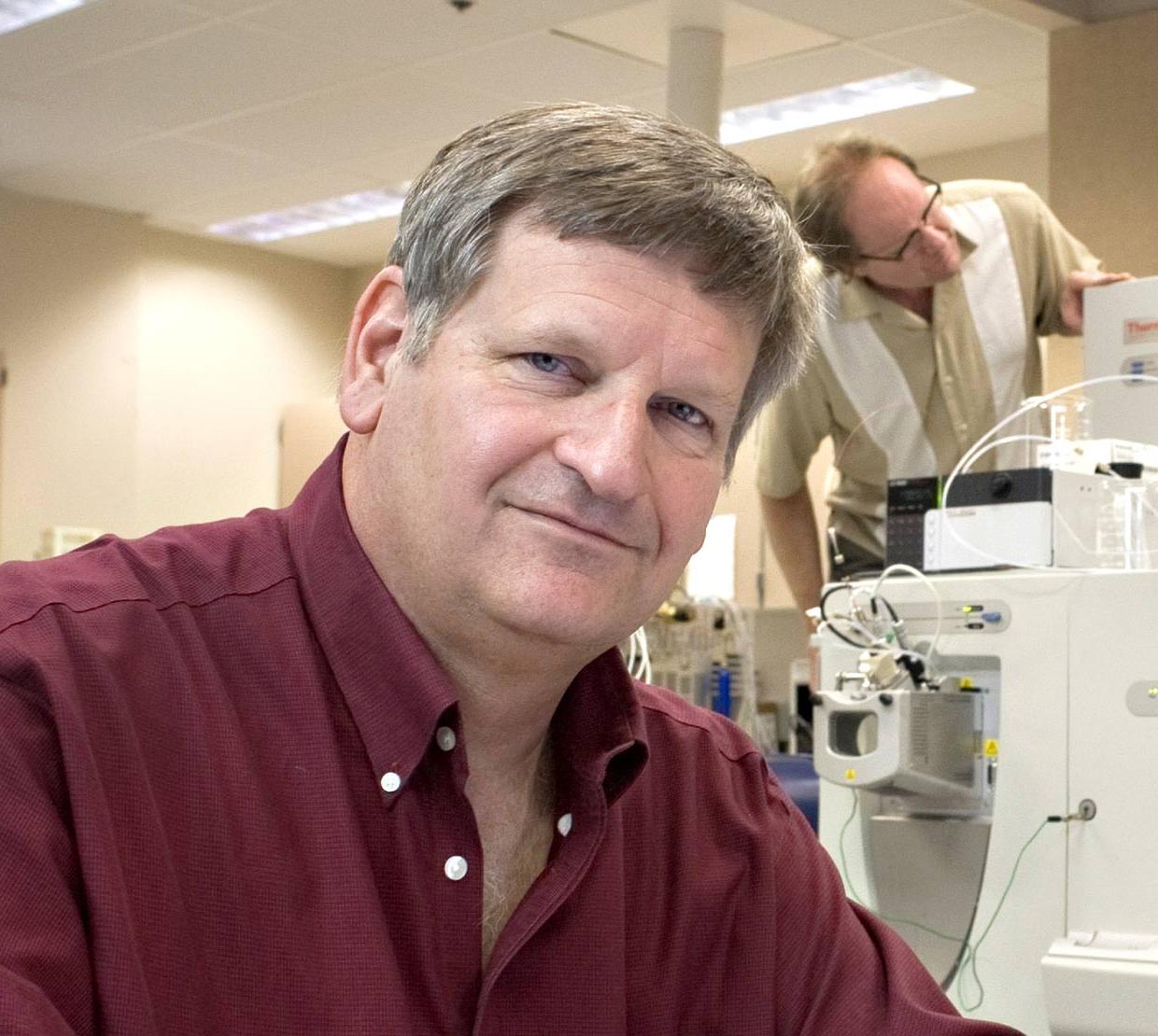 Joe Beckman in his lab with colleagues