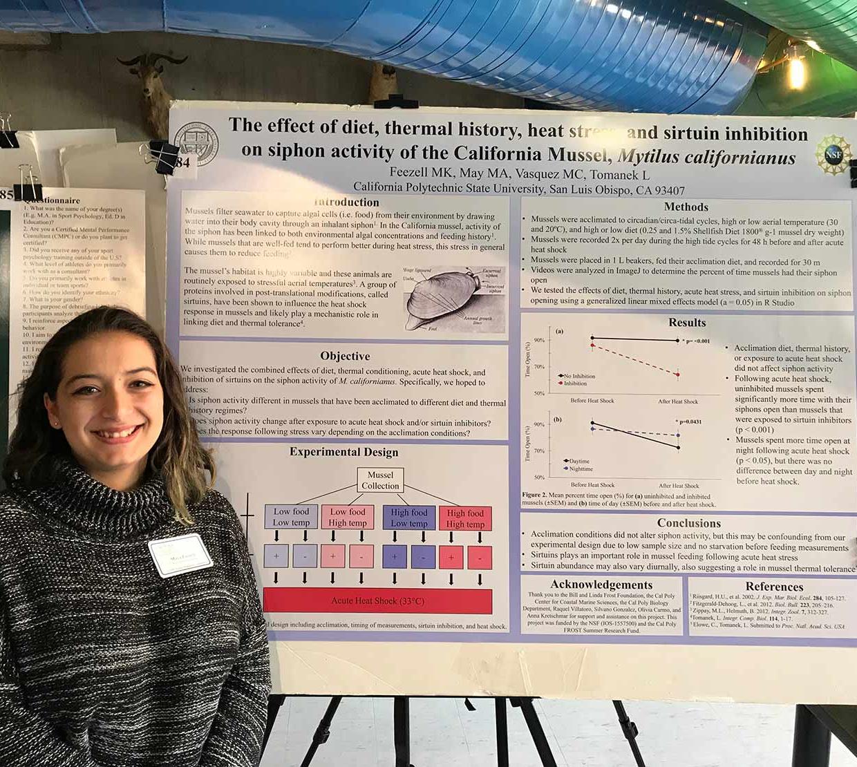 Maya Feezell standing next to her research poster