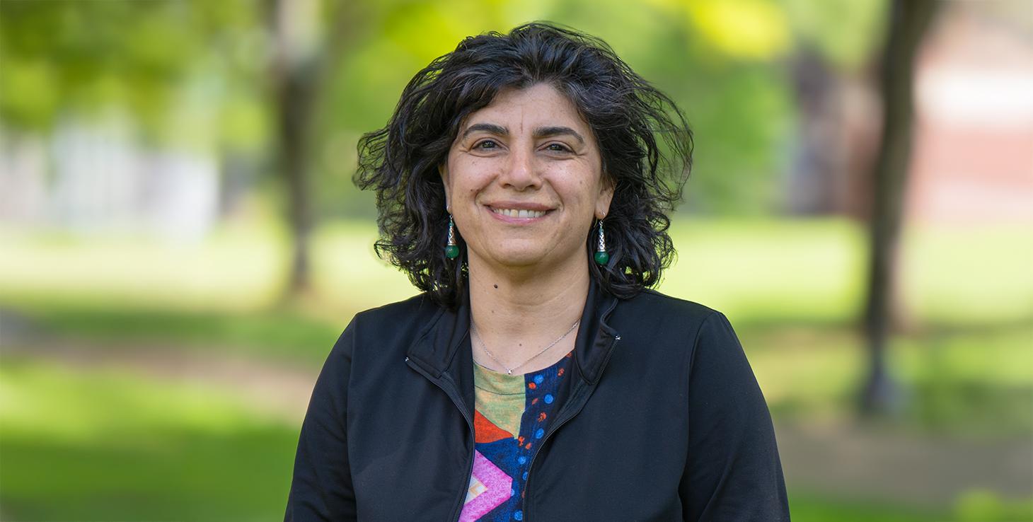 Elisar Barbar smiling on OSU campus in a colorful shirt