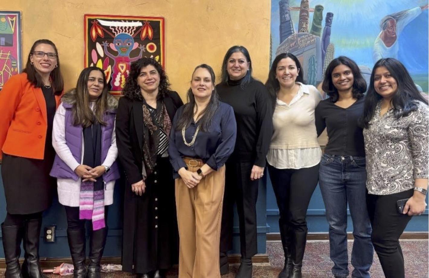 Eight women in an art-filled bulding