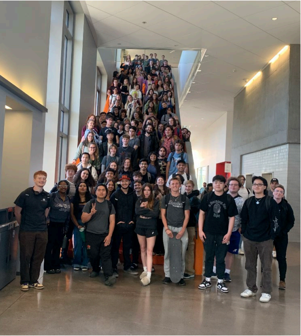 Big group of people posing and smiling for camera.