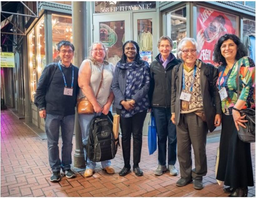 Group of people smiling at camera.