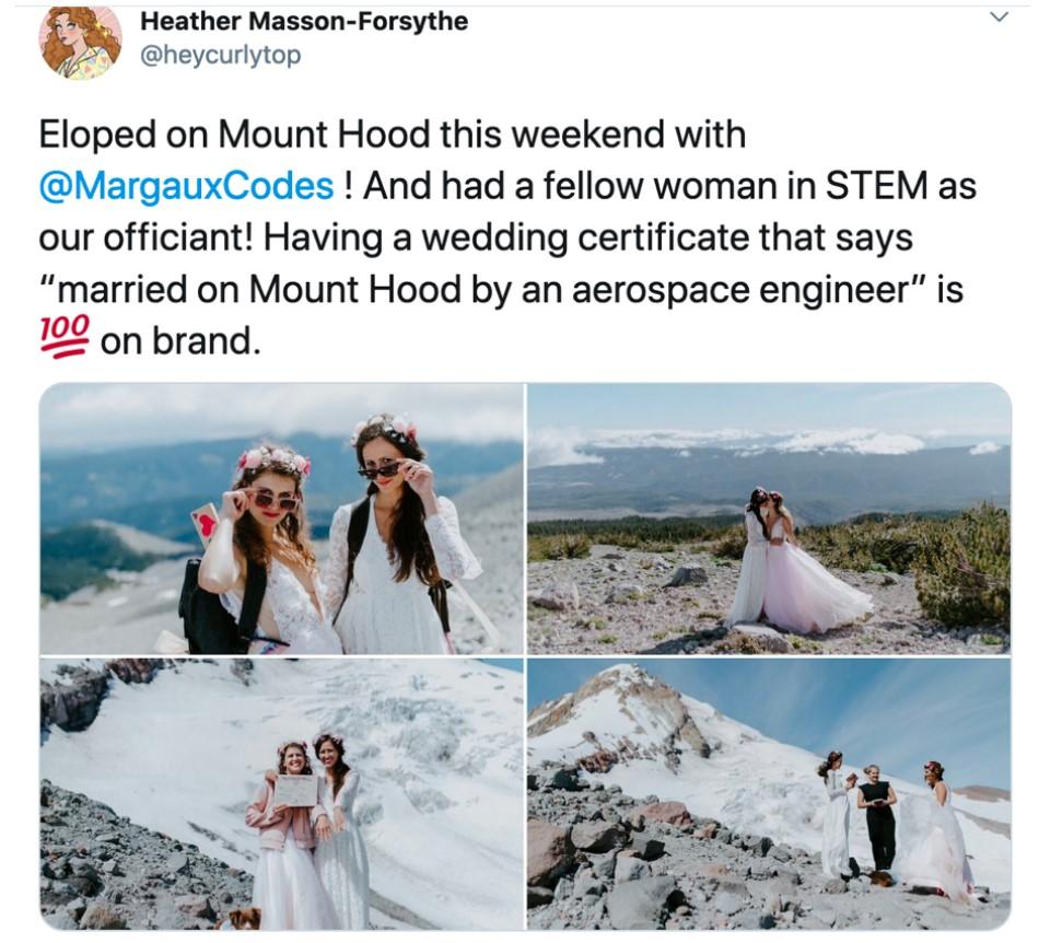 Two women getting married on a mountain.