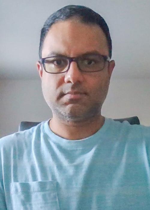 Man in glasses and blue shirt.