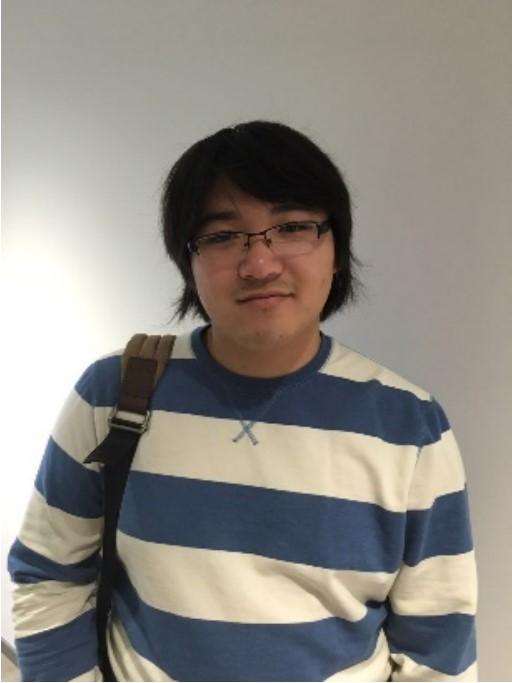 Man in glasses smiling at camera.