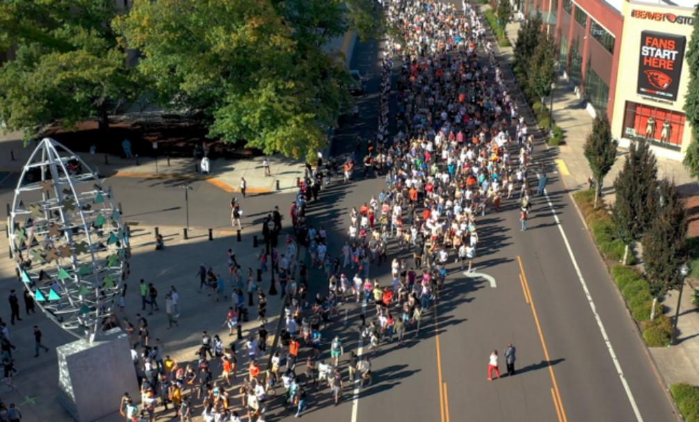 Students in masks walking down the street.