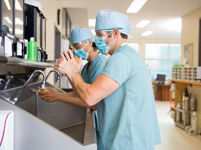 Two doctors washing their hands in a hospital.