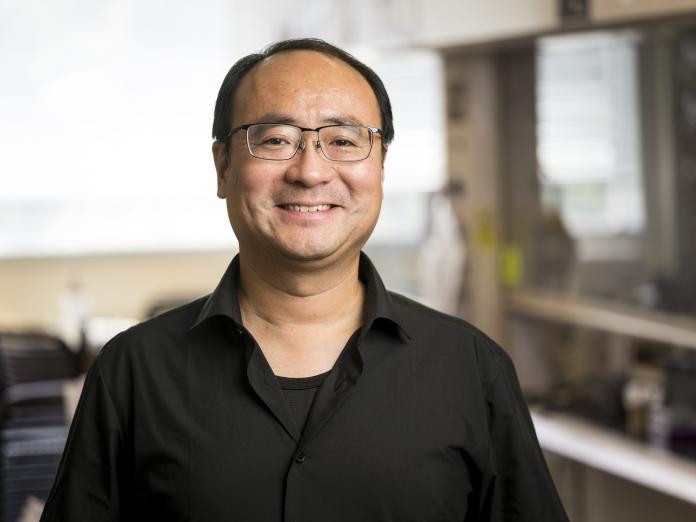 Headshot of Chong Fang smiling in his chemistry lab