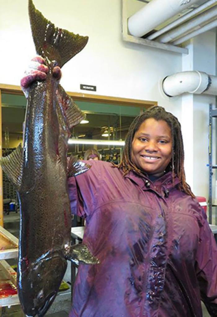 Nicole Hams holding salmon in lab