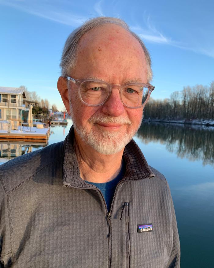 Headshot of Michael Albrich standing in front of a lake