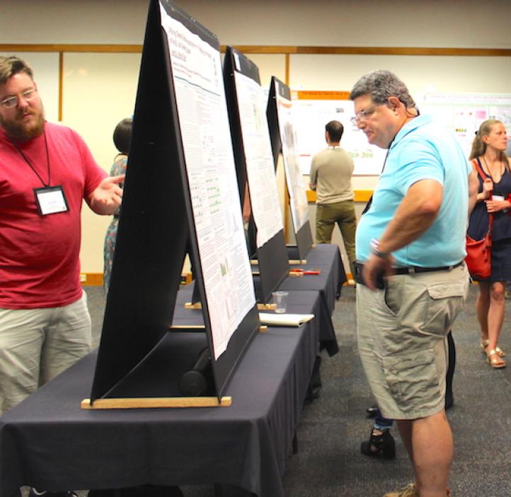 attendees looking at poster displays